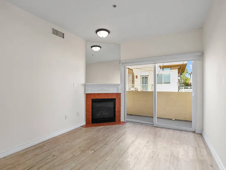 Living Room Space with Electric Fireplace and Private Balcony