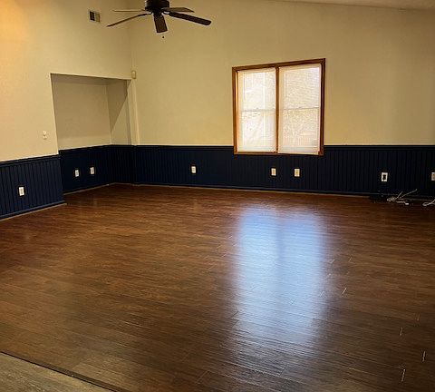 Spacious living area with vaulted ceiling.