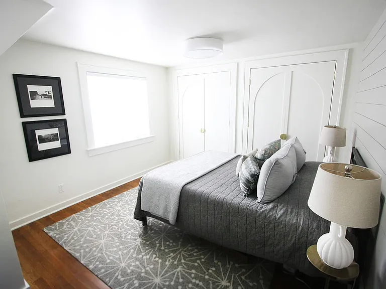 This light filled bedroom has a stocked closet with a fan, hangers, extra blanket and plenty of room for your belongings.
