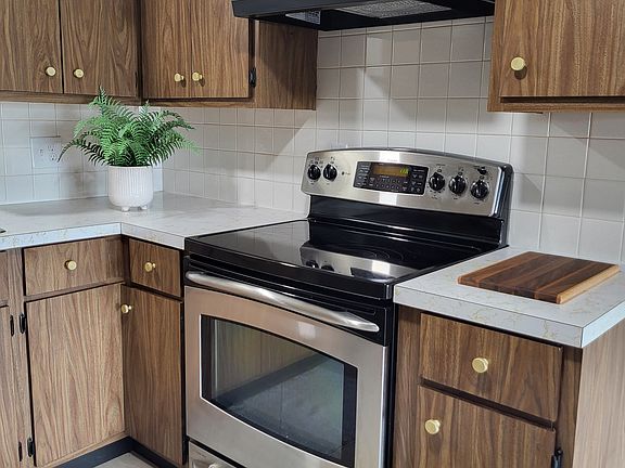 Updated stainless steel range and new fan/light hood, among other kitchen updates