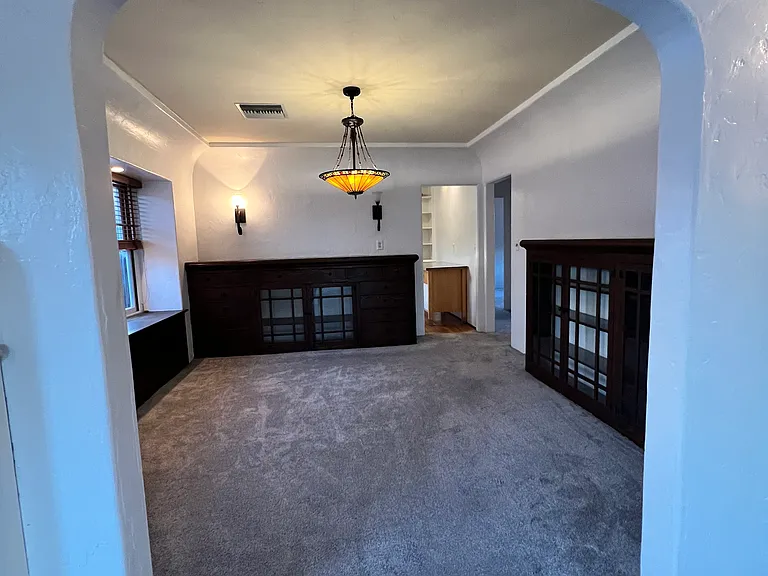 dining room with built in book case, buffet window seat with storage