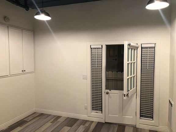 Dutch door entry that provides great ocean air flow. Deep, roomy storage cabinets on the left wall. Wall heater on the right wall.