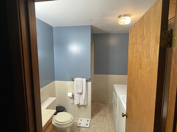 Master bath with washer and dryer.