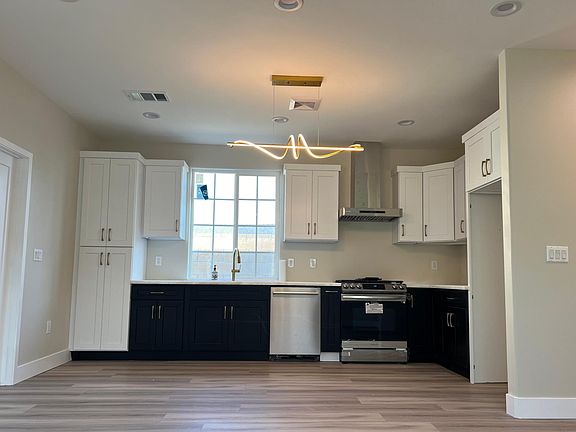 Brand new two toned cabinets, white quartzite countertops