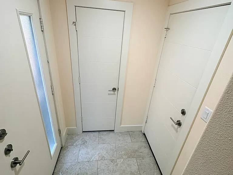 Downstairs entry way, garage entry and storage closet