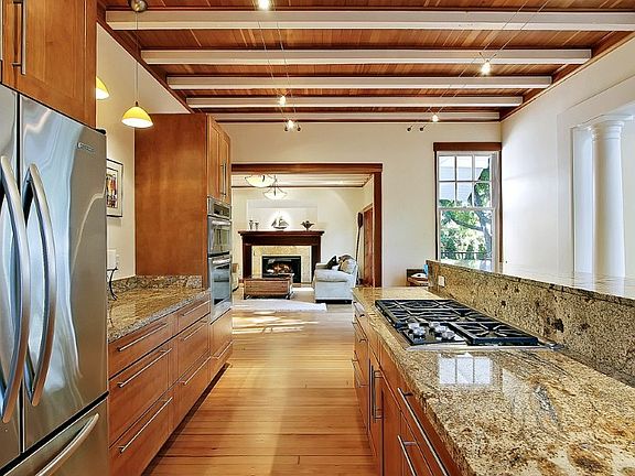 Grand light filled open floor plan with tall ceilings and period details