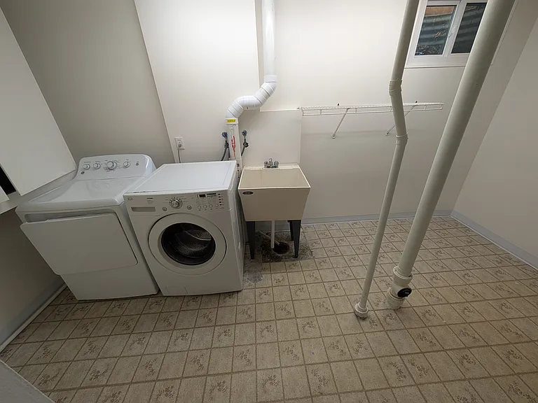 Large laundry room with utility sink