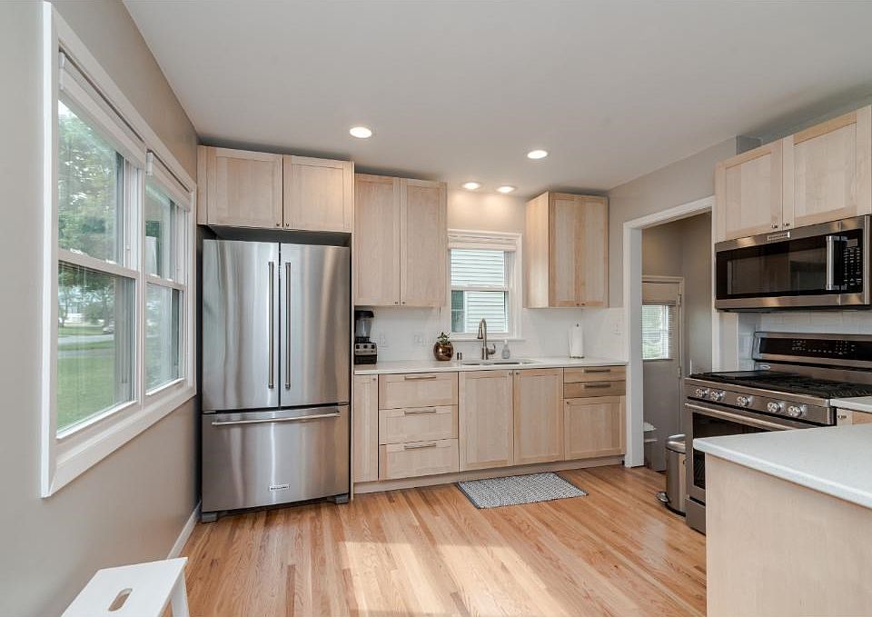 This custom kitchen features stainless appliances, new cabinets, quartz counter tops, dishwasher with panels to match cabinets, recessed lighting and new wood floors!