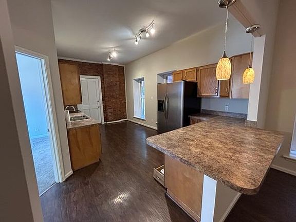 Kitchen with exposed brick accent wall