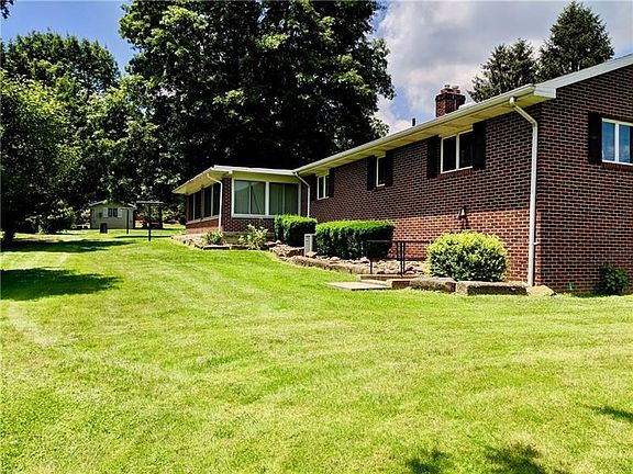 Back of the house. Large Sun Room to use year round for all your entertaining needs!