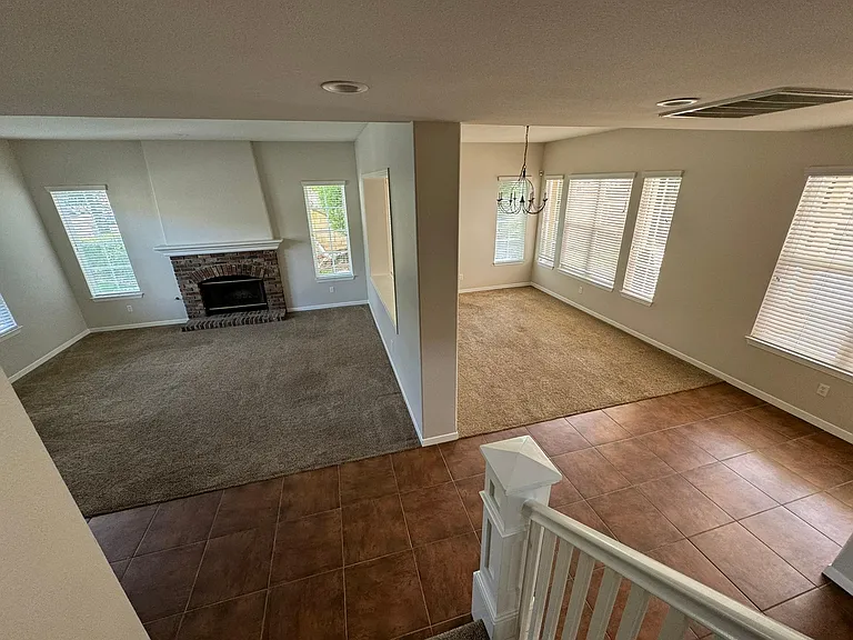 view from stairs down to foyer, living & dining/lounge areas