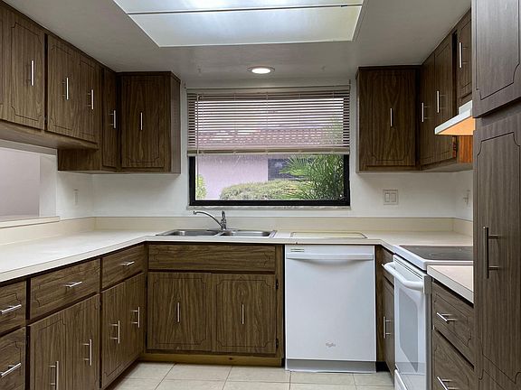 Large functionable Kitchen includes dishwasher, garbage disposal, range and refrigerator. There is a passthrough on the left into the living room is.