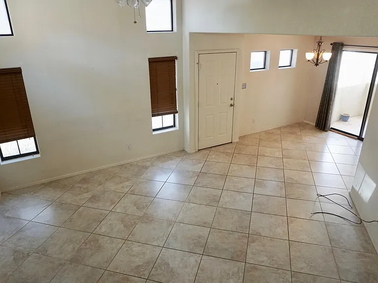 Spacious great room with vaulted ceiling, natural light, oversized tile.