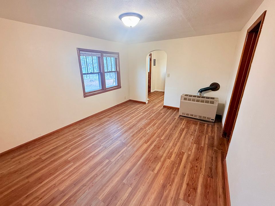Living room with doorway to kitchen and entry.