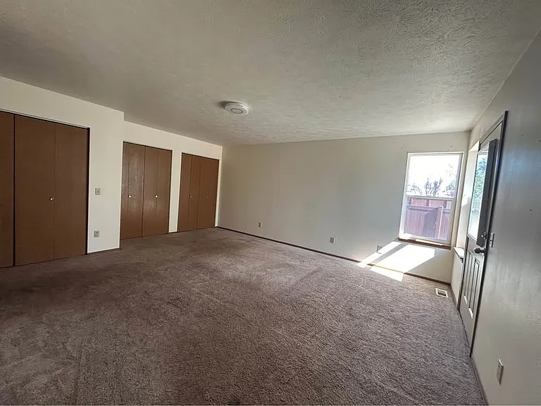 primary bedroom with backyard/ balcony access