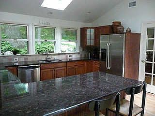 Windows overlook private, wooded back 