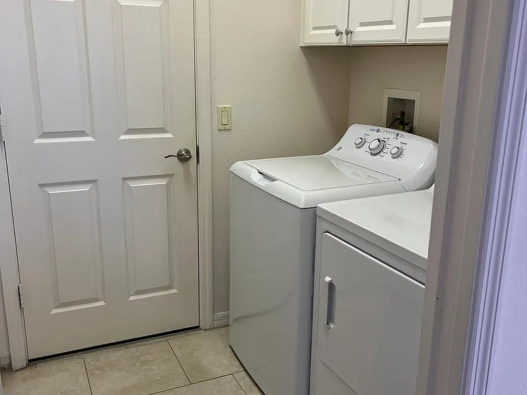 Laundry room has washer/dryer, laundry tub and storage.