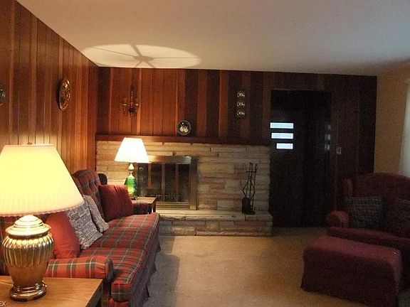 Living room with wood-burning fireplace.