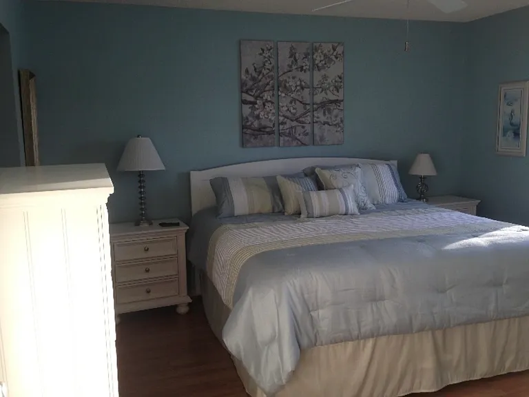 Master bedroom with lake view and king size bed