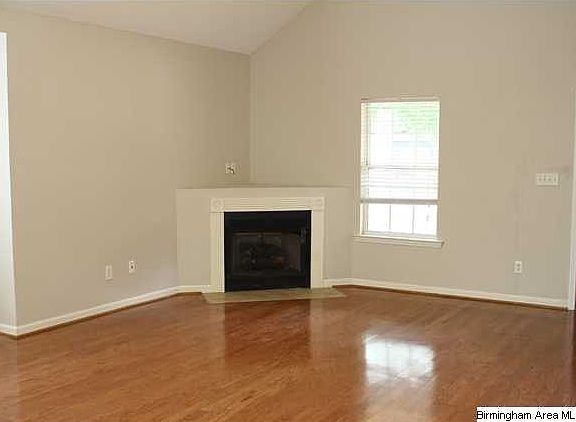 Great room with vaulted ceilings, new paint, and new hardwood floors