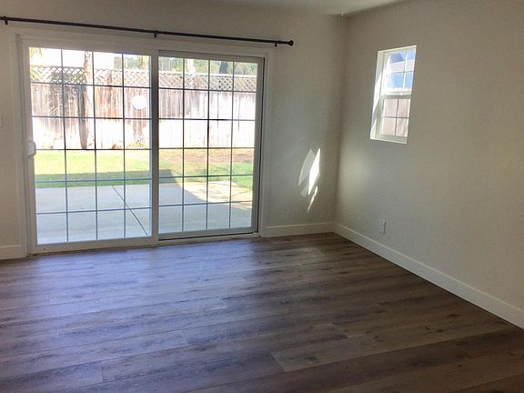Living room with sliding window to private garden.