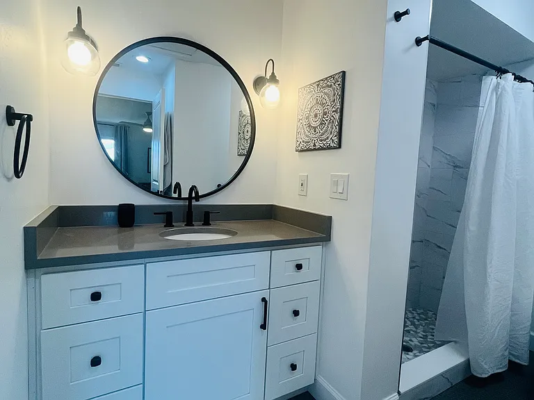 Ensuite bathroom, with walk in shower and a second full closet for additional storage (not captured in picture).