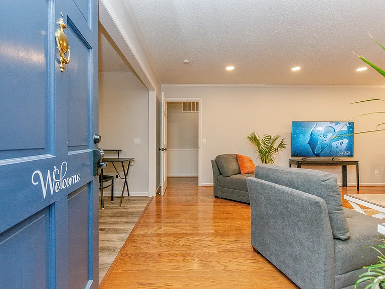 Walking in the front door. Living room is off to the right and the dining and kitchen are off to the left.