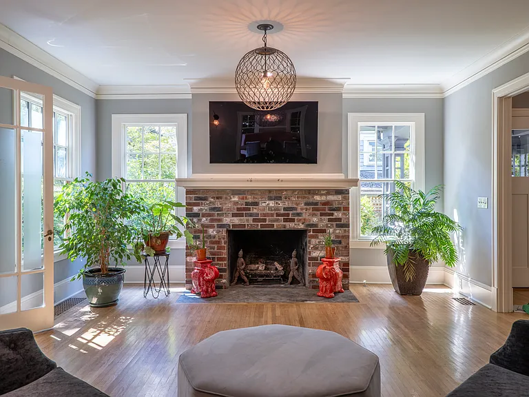 Huge living room with fireplace and large curved couch. TV comes down lower on an arm for ease of use. Tall 9'2" ceilings.