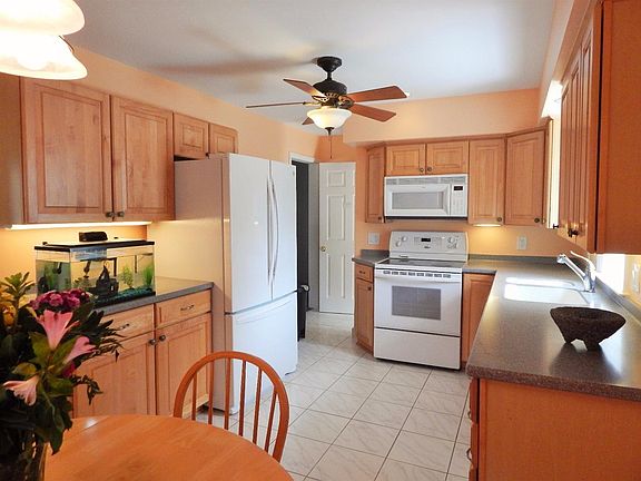 View of the Kitchen From Dining area.  Note Corian Counter Tops and Tile Flooring.
