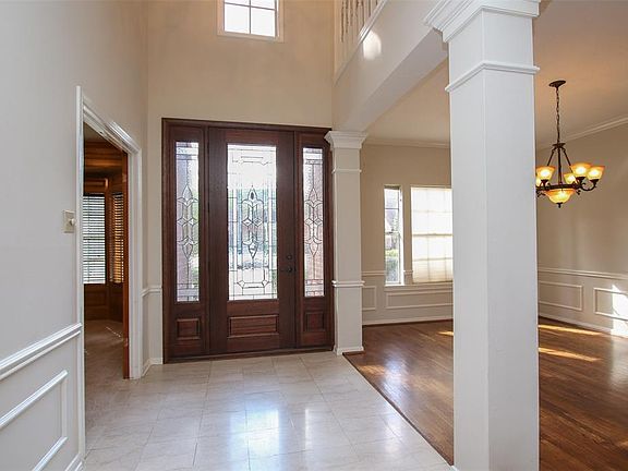 The entry is highlighted with a classic, leaded glass front door with matching sidelights.
