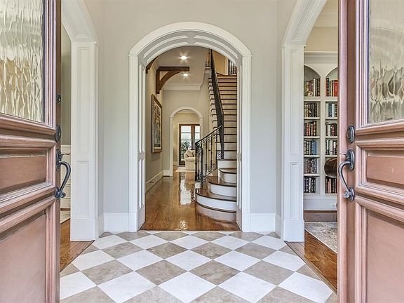 Gracious foyer with groin vault entry greets you with library and formal dining on either side.