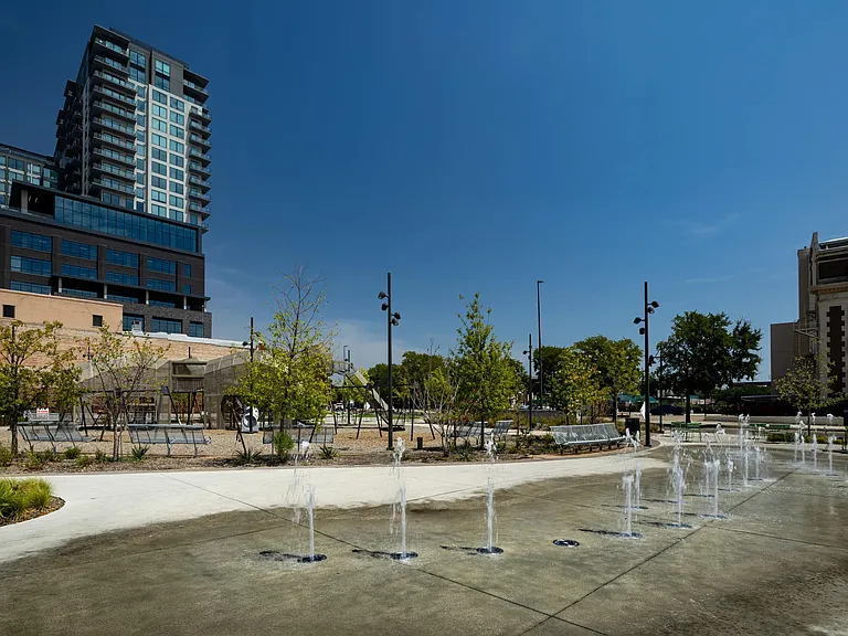 Nearby green spaces provide peaceful escapes from the bustling cityscape in downtown Dallas, TX.