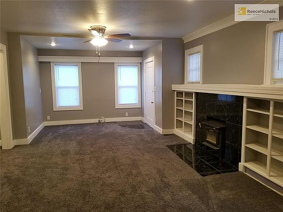 Living room with fireplace and built in shelving