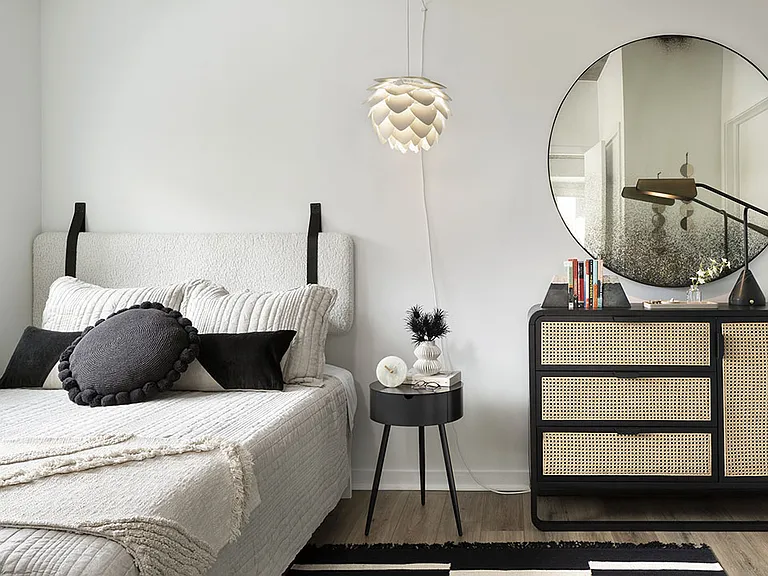 Spacious apartment bedroom with wood floors.