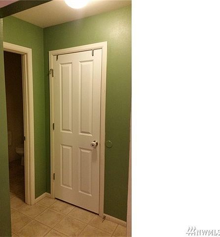 Linen closet on the main floor. Door to the left leads into the powder room.