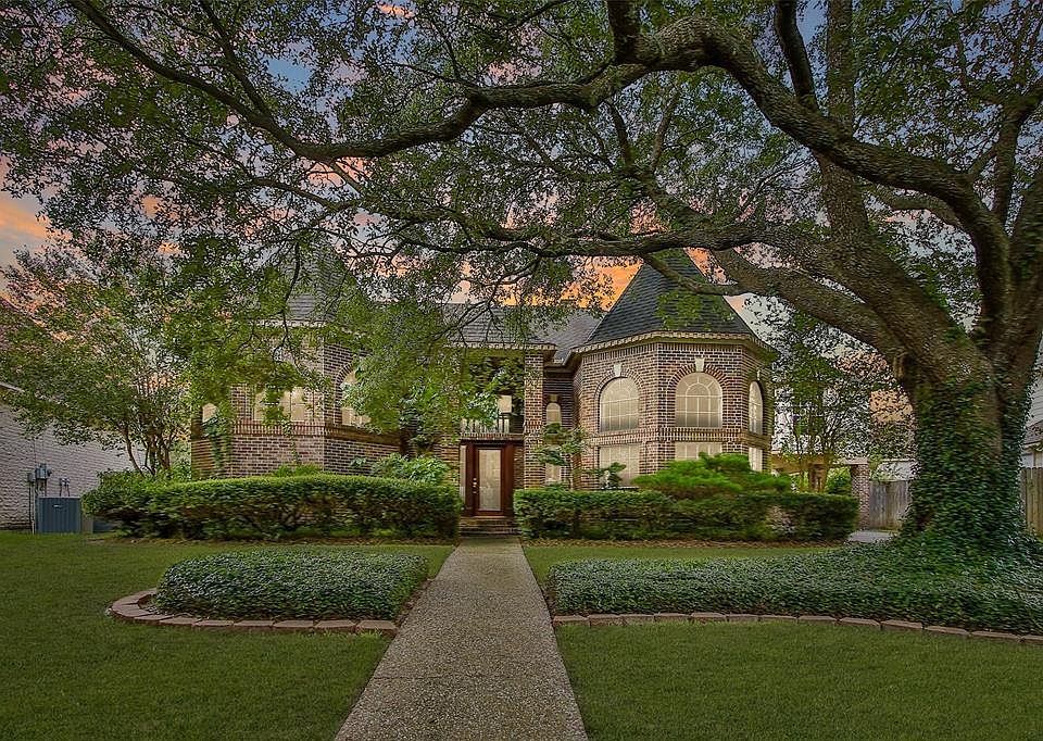The well-shaded front yard is nicely landscaped