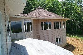 This home has twin deltec (round) sections with a connector and full walk-out basement.