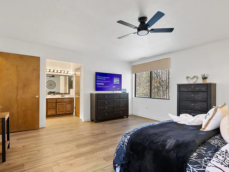The extra-large main bedroom features a king-sized adjustable base bed, a private en suite with double sinks, and a walk-in shower.