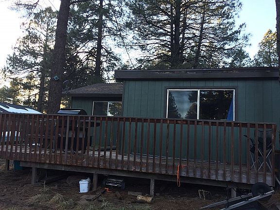 back of house with deck