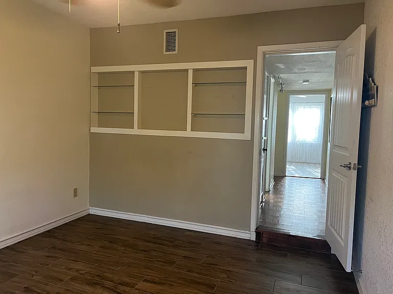 Breakfast room features decorative shelving, hallway access