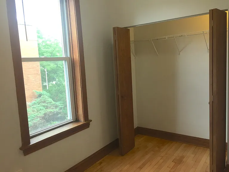 Rear bedroom window overlooks side yard garden space.