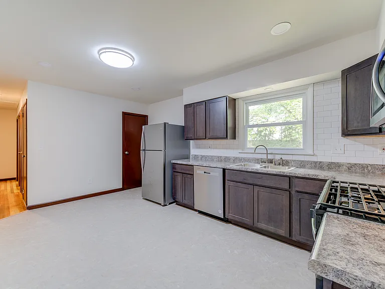 The kitchen has a pantry above the stairs to the basement.