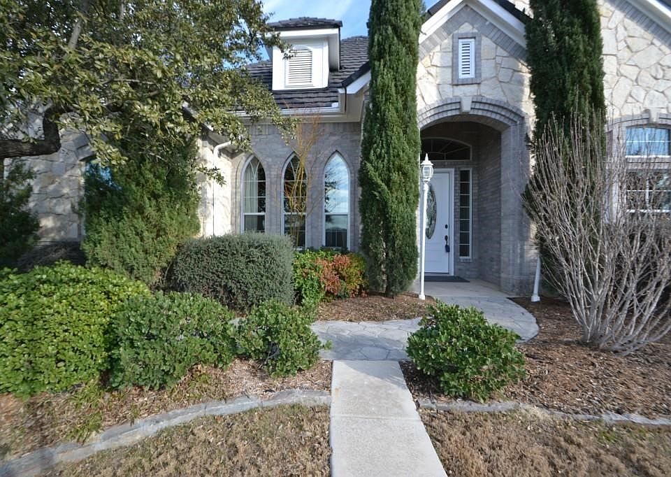 Beautiful Italian Cypress trees frame the Austin Stone entry. Incredible Stone coated steel with 50 year warranty.