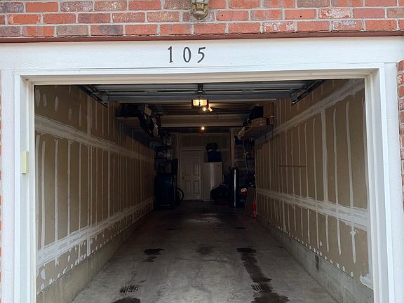 Tandem 2-car garage with lots of built-in shelving for extra storage