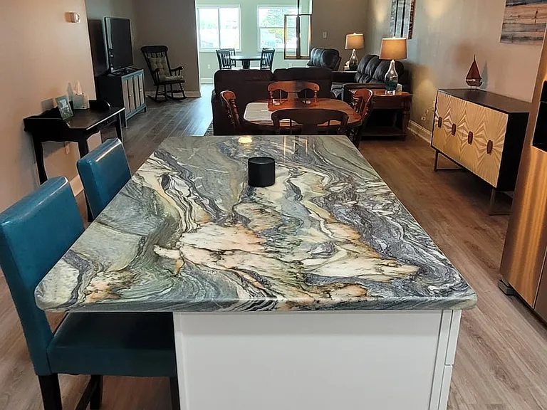 Kitchen island with luxury granite and matching bar stools welcomes you in to your new home away from home.