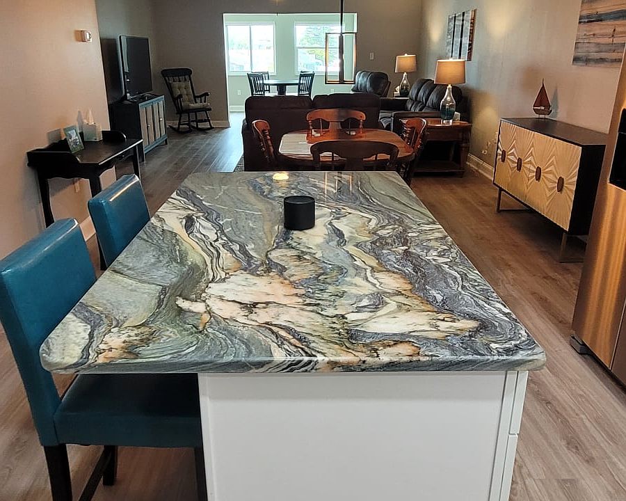 Kitchen island with luxury granite and matching bar stools welcomes you in to your new home away from home.