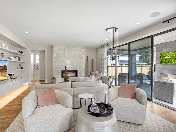 Great room flows to outdoor living through stacked sliding glass doors