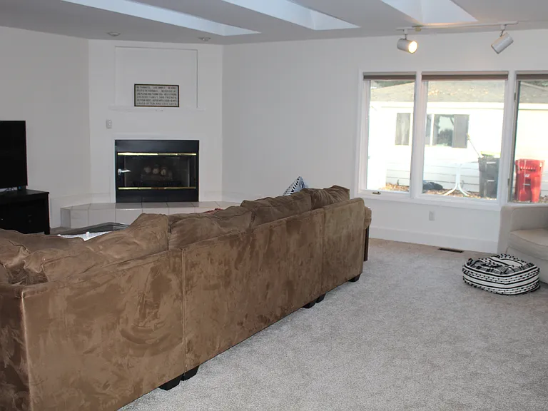 Family room with tv, couch, chair and fireplace