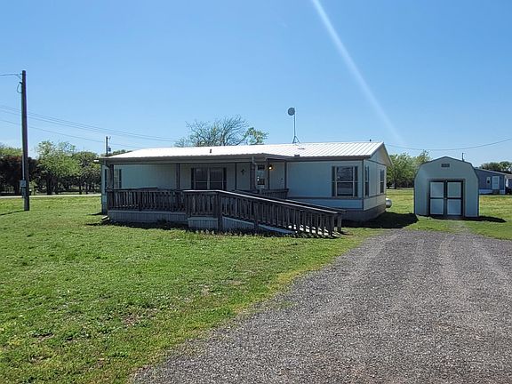 Front of House with Porch and Storage Shed