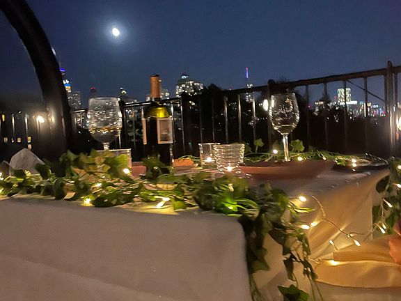 Roof at night with city view.